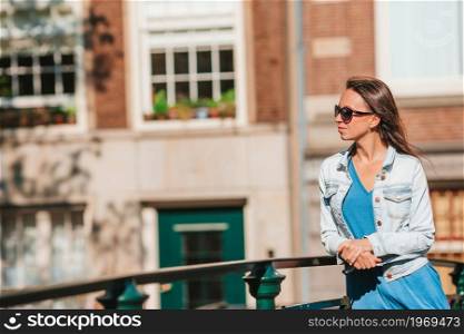 Young woman on european vacation in Amsterdam at the bridge. Happy young woman in european city