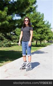 Young woman on roller skates in summer