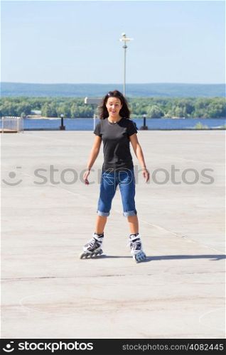 Young woman on roller skates in summer