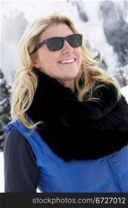 Young Woman On Ski Holiday In Mountains
