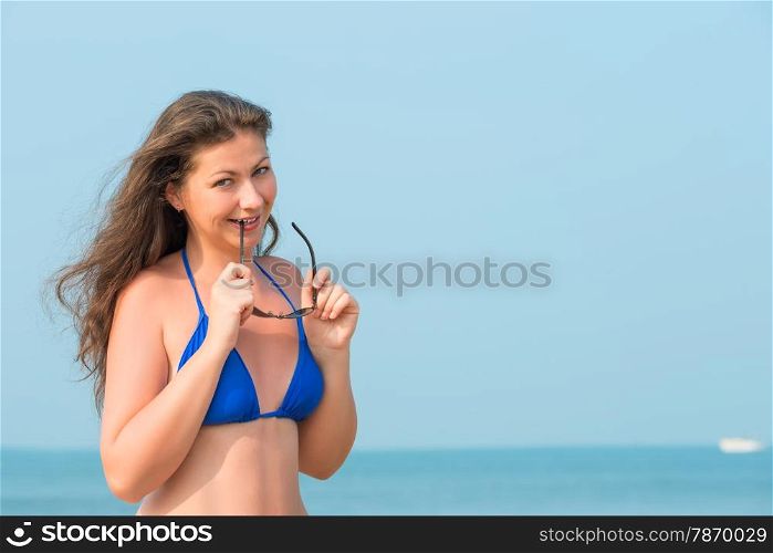 young woman on the beach and sunglasses