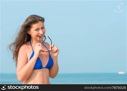young woman on the beach and sunglasses
