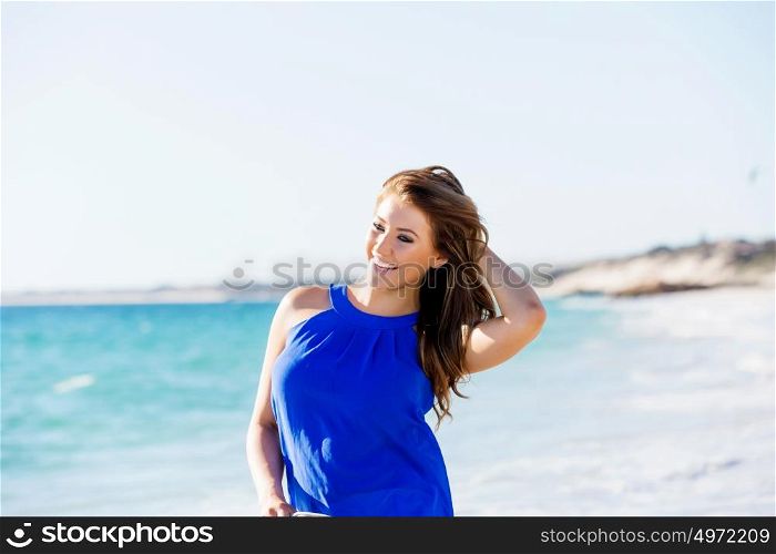 Young woman on the beach. Portrait of young pretty woman on summer day on the beach