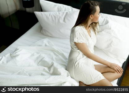 Young woman on the bed in the orning