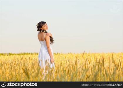 Young woman on wheat field