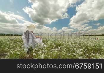Young Woman On White Field In Summer Tracking shot