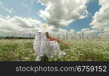 Young Woman On White Field In Summer Tracking shot