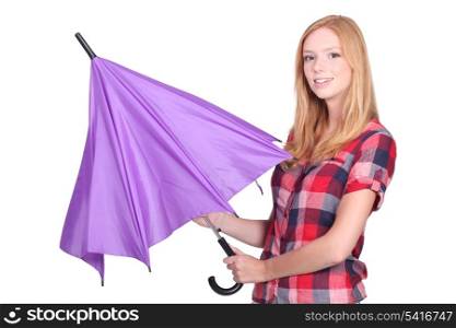 Young woman opening a purple umbrella