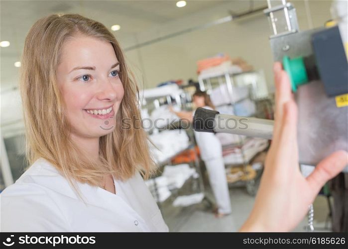 young woman operating a machine