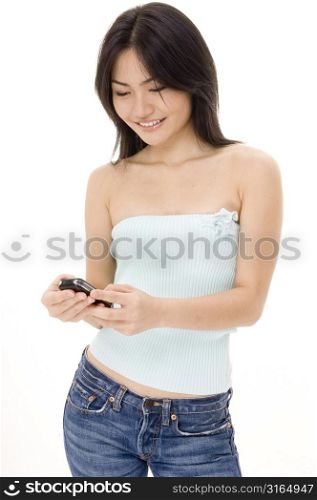 Young woman operating a mobile phone and smiling