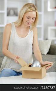 young woman packing a box