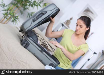 young woman packing for vacation