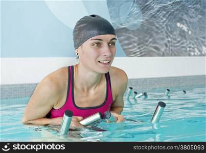 young woman pedal in a training of aquabiking