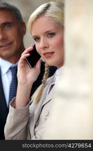 Young woman pensive on phone