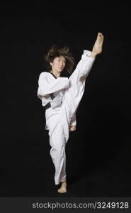 Young woman performing front kick