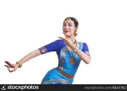 Young woman performing Indian Bharat Natyam dance over white background