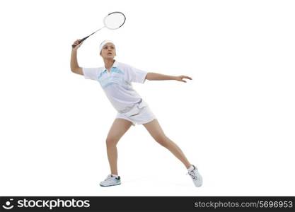 Young woman playing badminton isolated over white background