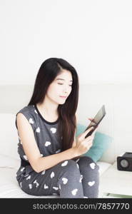 Young woman playing games on tablet