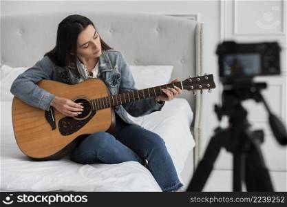 young woman playing guitar