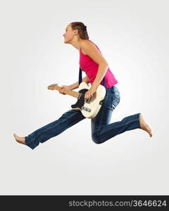 young woman playing on electro guitar and jumping