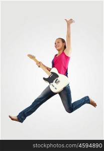 young woman playing on electro guitar and jumping