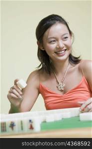 Young woman playing with blocks and smiling