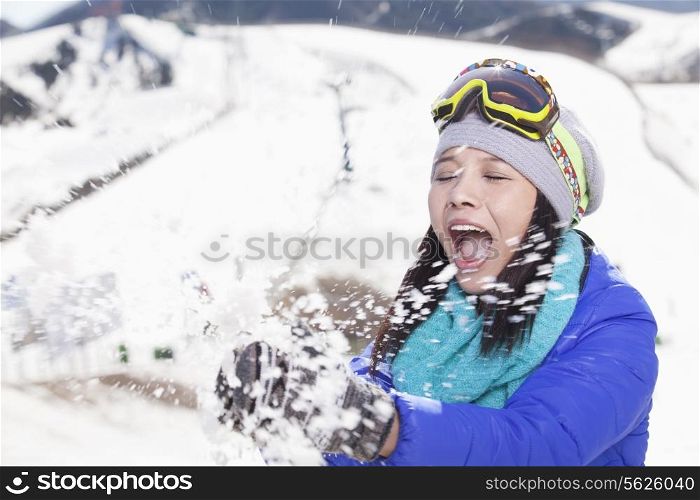 Young Woman Playing With Snow