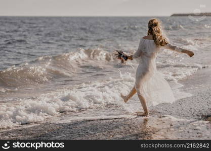 Young woman playing with waves of happiness by the sea in Turkey