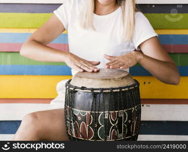 young woman playing yuker drum