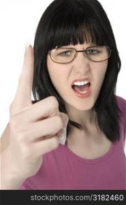 Young woman pointing and yelling towards camera.