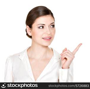 Young woman points to the side in white shirt - isolated on white background.