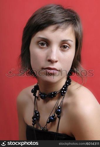 young woman portrait isolated on red background