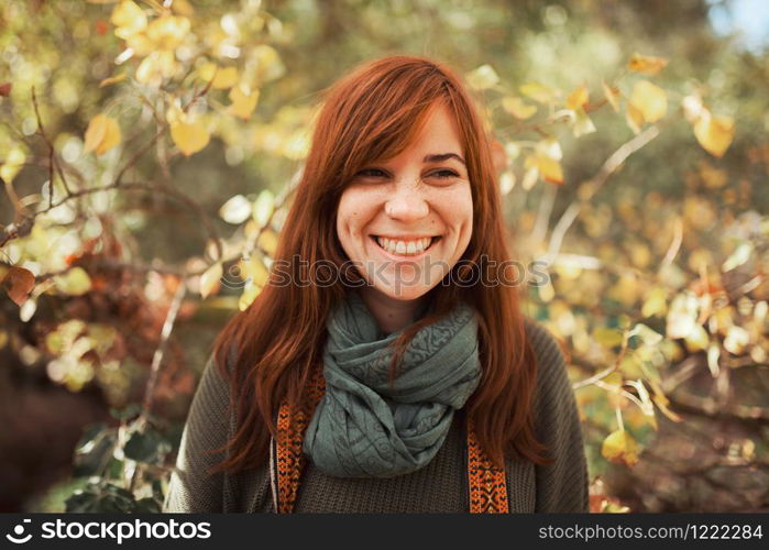 Young woman portrait looking at the camera in the forest