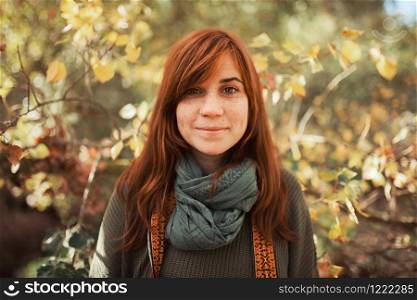 Young woman portrait looking at the camera in the forest