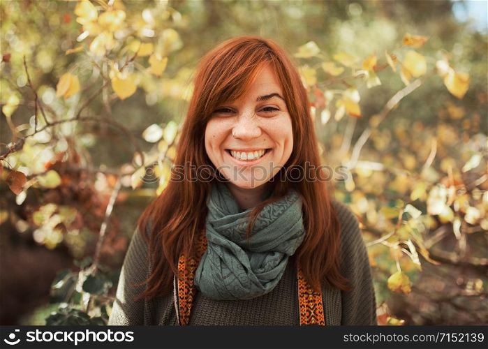 Young woman portrait looking at the camera in the forest