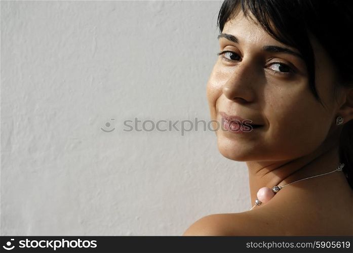 young woman portrait looking sexy in a white wall