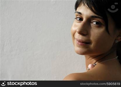 young woman portrait looking sexy in a white wall