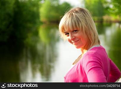 Young woman portrait on nature background in summer