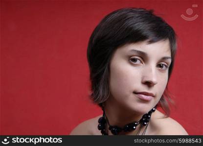 young woman portrait on red background