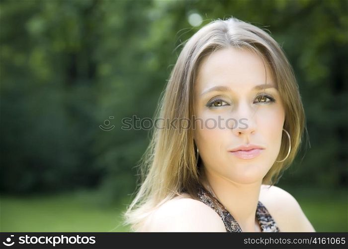Young Woman Portrait On The Nature Background