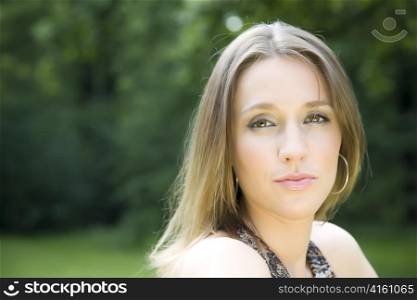 Young Woman Portrait On The Nature Background
