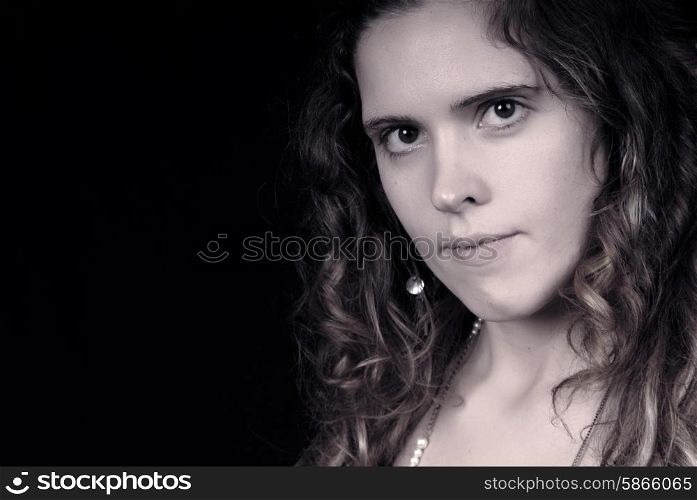 Young woman portrait posing in black background