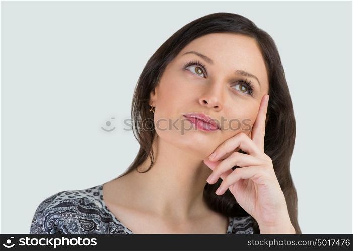 Young woman posing against white background. Beautiful young cheerful lady