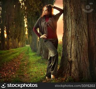 Young woman posing at autumn sunset