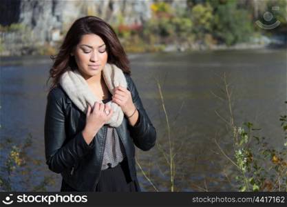 Young woman posing by the river