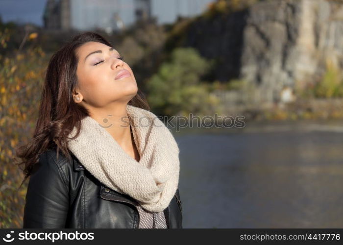 Young woman posing by the river