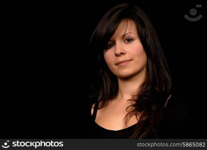 Young woman posing in black background