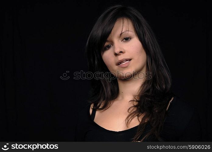 Young woman posing in black background