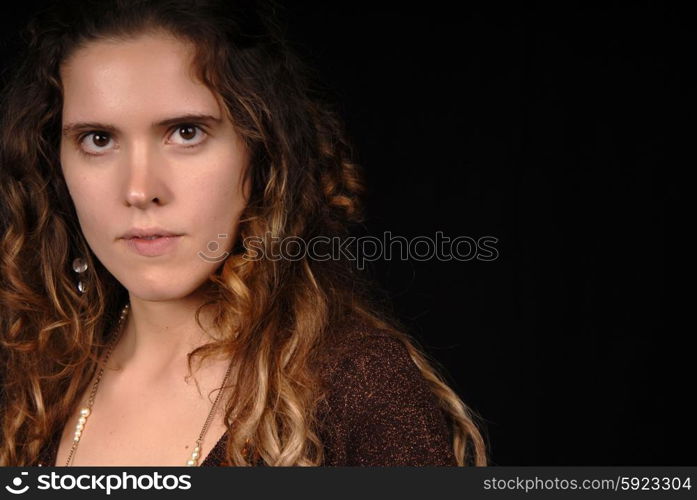 Young woman posing in black background