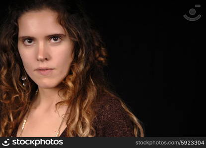 Young woman posing in black background